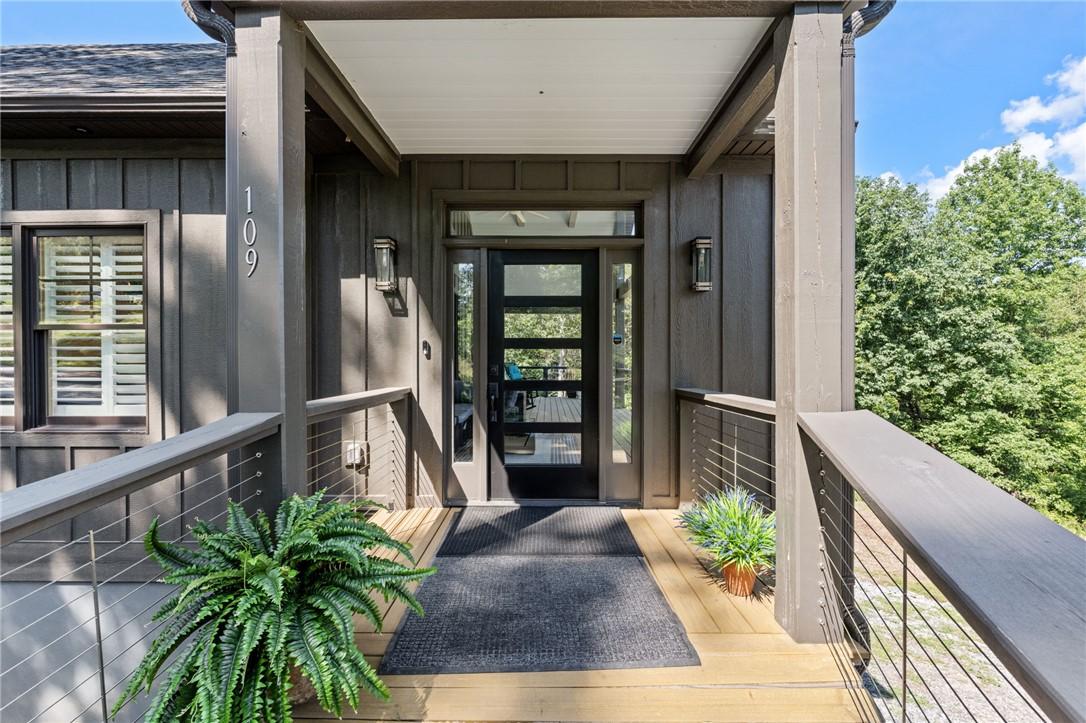 Image 4: A welcoming entry features a modern glass panel do