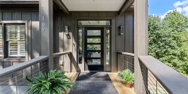 Image 4: A welcoming entry features a modern glass panel do