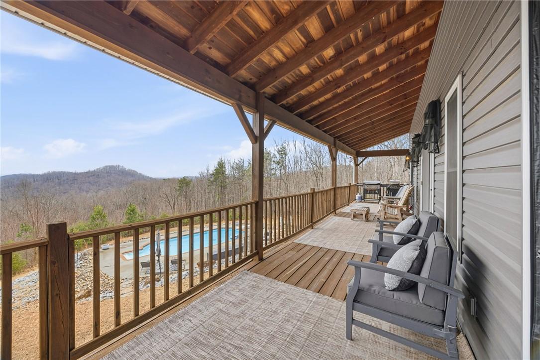 Image 2: This expansive porch offers serene mountain vistas