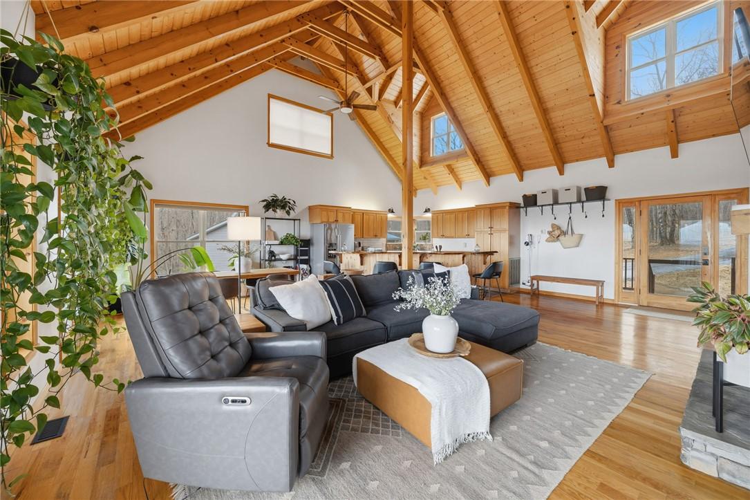Image 4: This airy living space features soaring wood-beame