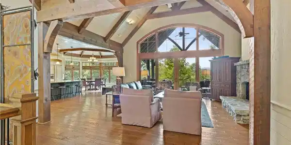 Image 4: A grand great room features soaring vaulted ceilin