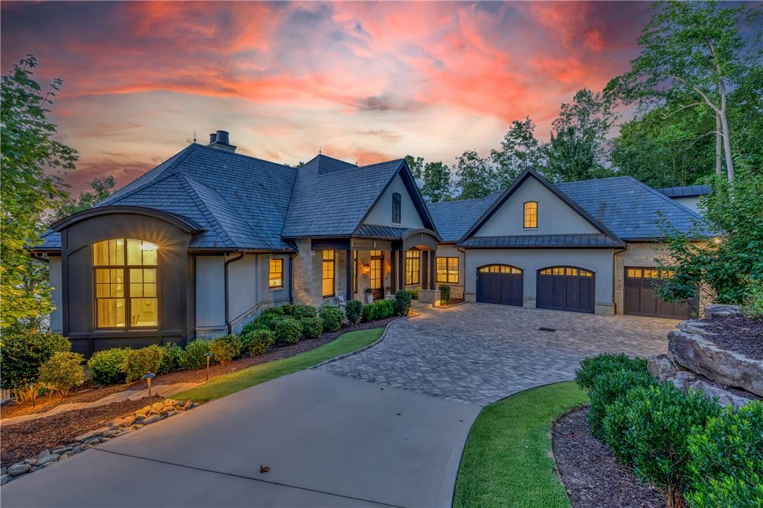 Image 3: A grand estate with a sweeping paved driveway, mul