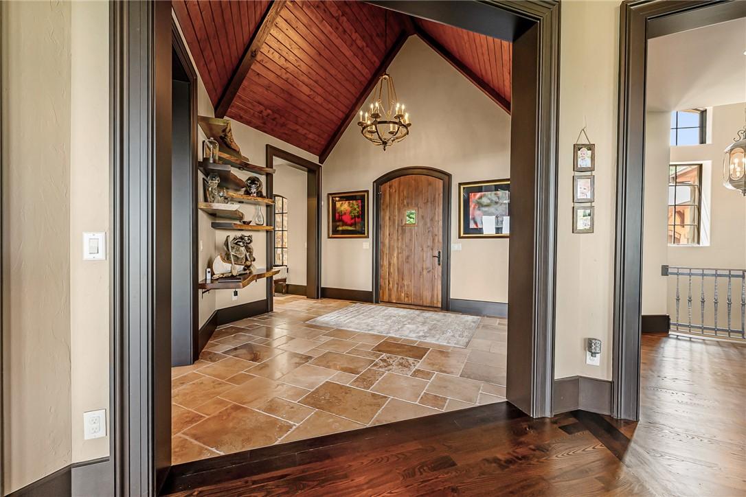 Image 4: Rich wood and stone floors create a warm, inviting